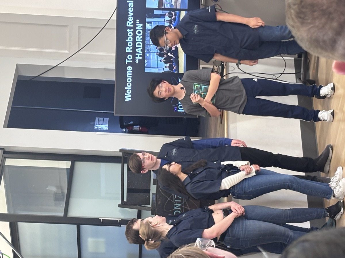 Etienne with teammates at the reveal of the team's robot, Hadron